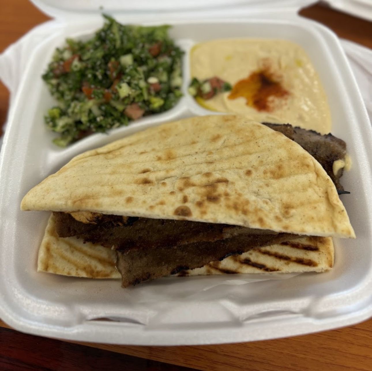 Gyro plate with tabbouleh, hummus, and pita